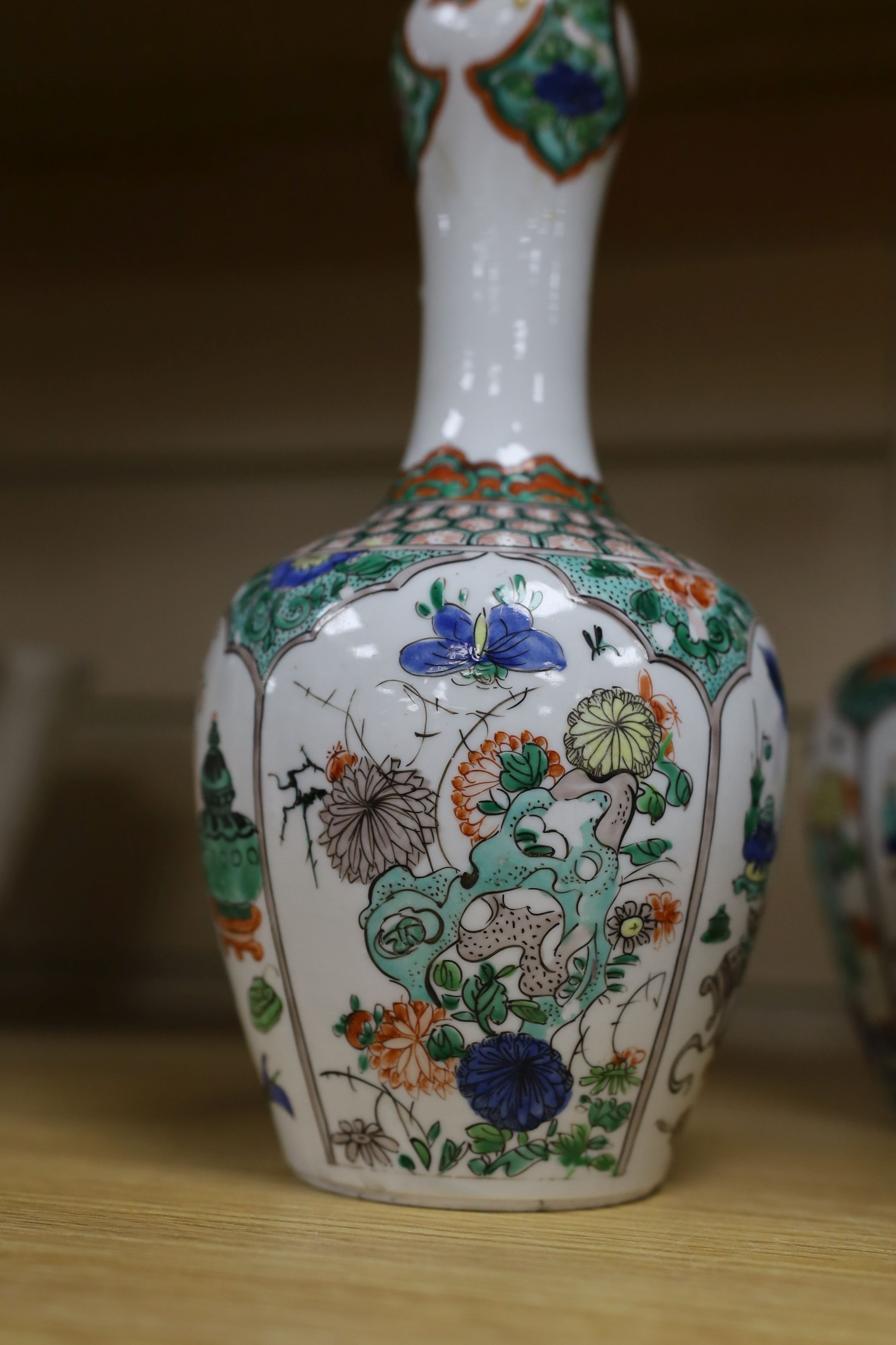 A pair Samson of Paris vases in the Chinese famille verte style and a Chinese Qianlong famille rose garlic neck vase with blue panelling motif, tallest 26cm